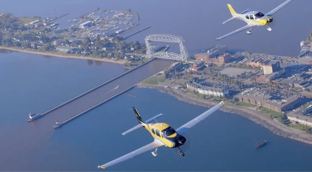 cirrus airplanes flying above duluth lift bridge